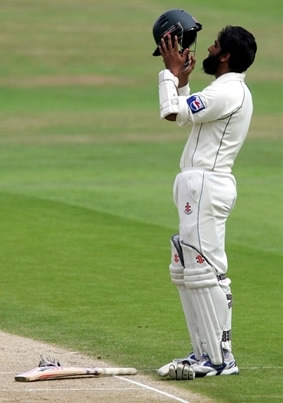 Mohammad Yousuf holds his helmet while celebrating century