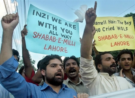 Pakistani activists of Shabab-e-Milli carry placards and shout slogans against Darrell Hair