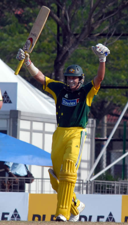 Hussey raises his bat after his century