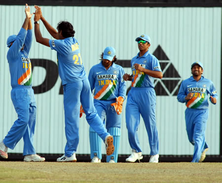 Indian players celebrate after taking a wicket