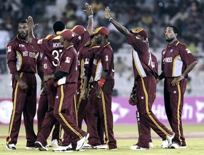 West Indies cricketers celebrate after taking a wicket