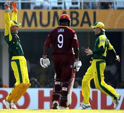 Gilchrist & Clarke celebrate as Lara walks back to the pavilion