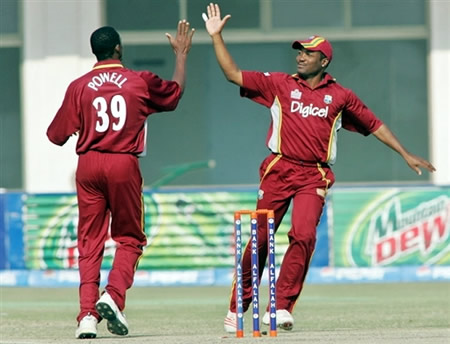 Powell and Lara celebrate the wicket of Faisal Iqbal