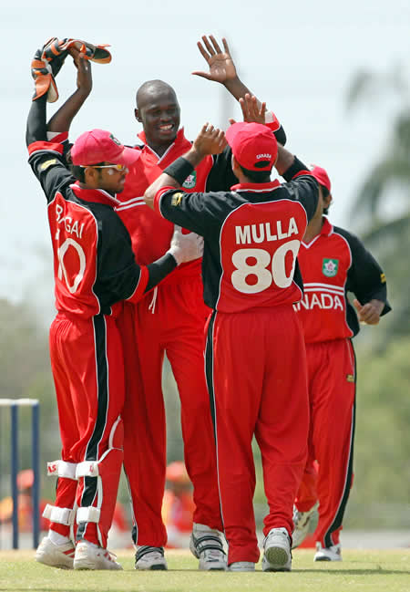 Henry Osinde celebrates the wicket of Shoaib Malik with his teammates