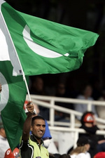 A supporter waves a Pakistani flag in celebration