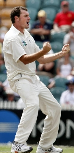 Kyle Mills celebrates the wicket of Ian Bell