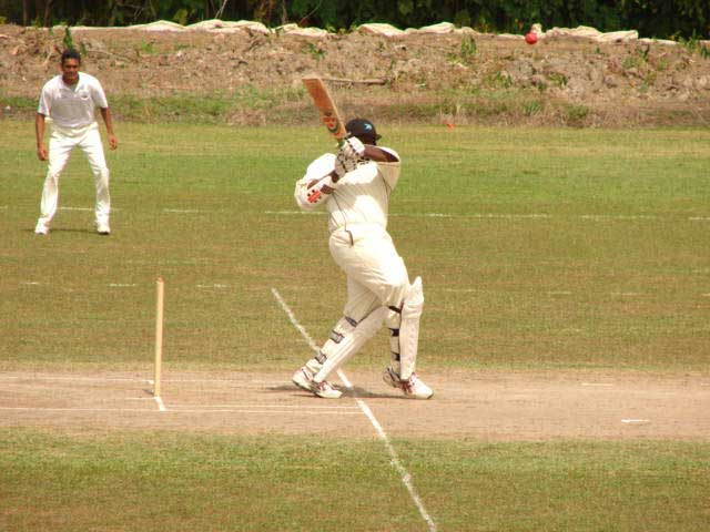 Gregory Taylor of the Bahamas on the hook looking for valuable runs against Suriname