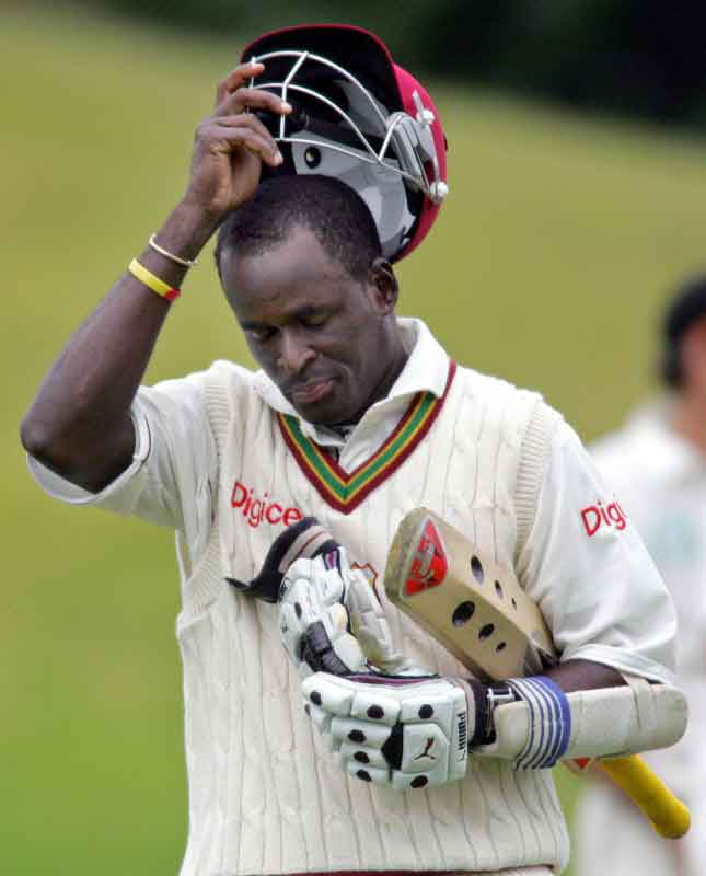 Rawl Lewis removes his helmet as he walks from the field after his dismissal