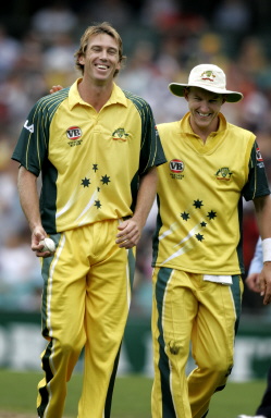 Glenn Mcgrath (L) cheered by fellow fast bowler Brett Lee (R)