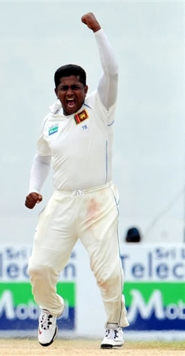 Herath celebrates after taking the wicket of Fawad