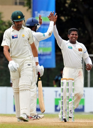 Herath celebrates the wicket of Umar Gul