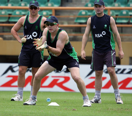 Niall O'Brien takes the catch as Gary Wilson and William Porterfield look on 