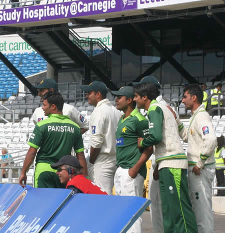 Pakistan players are ready to run in to celebrate their historic win