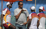 Courtney Walsh talks to members of the West Indian team at a training session