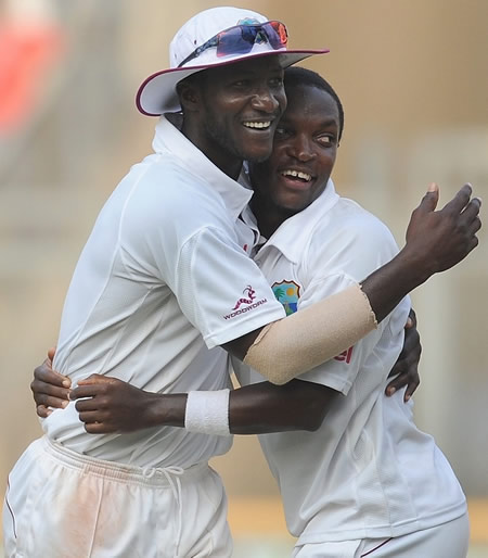 Darren Sammy and Fidel Edwards celebrate after a last-ball draw