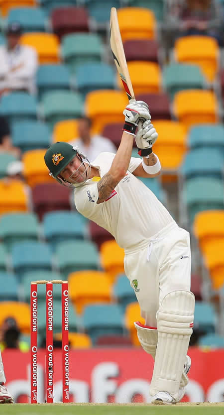 Michael Clarke drives down the ground