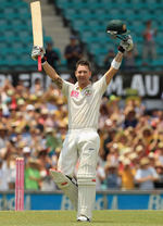 Michael Clarke raises his arms after reaching his hundred