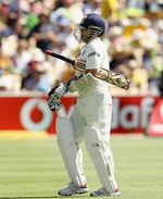 Sachin Tendulkar walks back after being dismissed