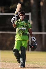 Babar Azam raises the bat after reaching his century