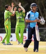 Pakistani players celebrate after taking a wicket