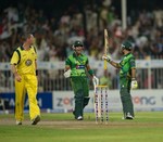 Asad Shafiq raises his bat and Umar Akmal motivates him