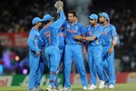 Indian players celebrate after taking a wicket