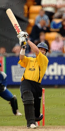 Matthew Elliott drives a ball for six, almost into the Mumbles Road