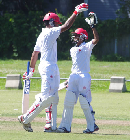 High fives exchanged as Ruvindu Gunasekera (left) celebrates his century with Salman Nazar