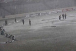 Groundsmen bringing the covers