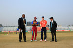 England captain flicks the coin as the West Indies captain looks on