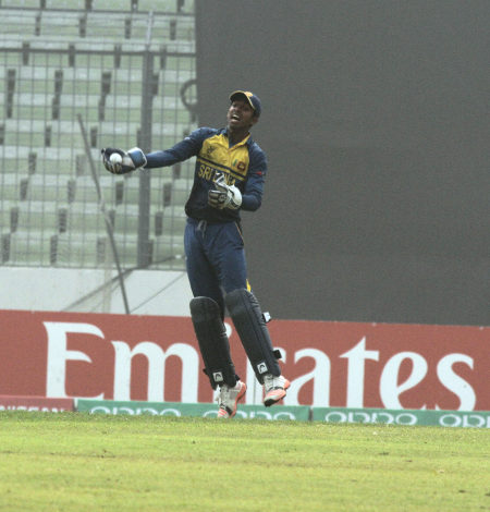 The Sri Lankan keeper celebrates after taking a catch