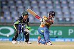 Chamari Atapattu Captain of Sri Lanka hits out with Alyssa Healy of Australia looking on