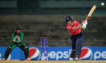 Charlotte Edwards, Captain of England hits the ball towards the bounadry, as Sidra Nawaz of Pakistan looks on