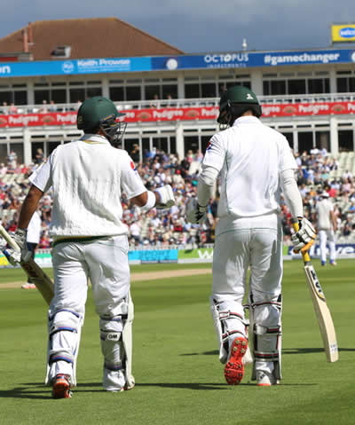 Pakistan openers walk to the middle