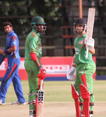 Ryan Burl raises his bat in reaching 50