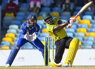 Rovman Powell launches on the leg side