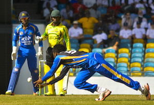 Jomel Warrican stoops to take a catch