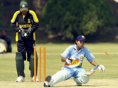 Savitha Nirala (R) falls after being bowled