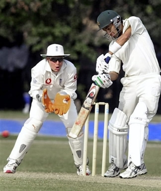 Hasan Raza (R) plays a shot as England wicketkeeper Geraint Jones (L) looks on