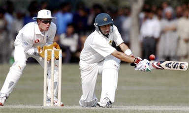 Hasan Raza (R) plays a sweep shot as Geraint Jones (L) looks on