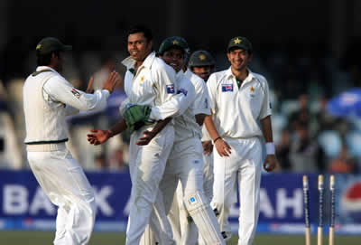 Danish Kaneria celebrates after taking a wicket