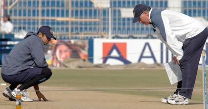 Chappel and Dravid inspecting the pitch