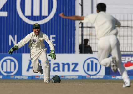 Razzaq and Kamran celebrate Sehwag's wicket.