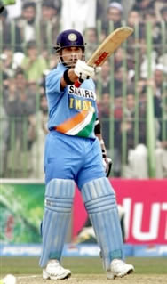 Sachin Tendulkar raises his bat after his century