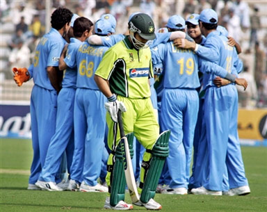 Kamran Akmal walks back to the pavilion