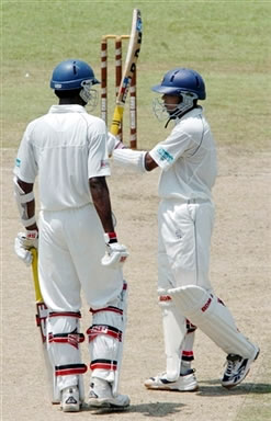 Dilshan raises his bat after his half century