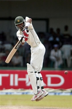 Shoaib Malik jumps into the air as he plays a shot