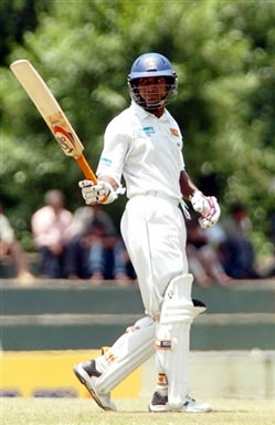 Sangakkara raises his bat after his half century