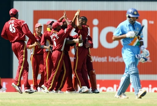 West Indies players celebrate the dismissal of Dravid